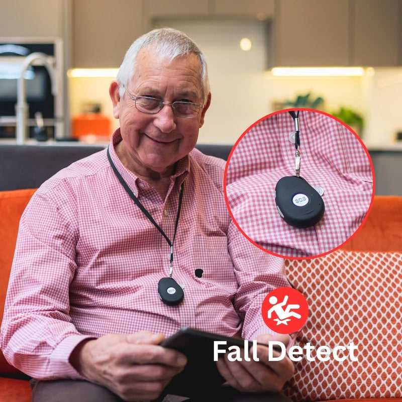 Older man wearing a HelpAlert fall detection pendant alarm at home. Close-up shows SOS button with fall detect feature, offering reassurance and immediate help if a fall happens.