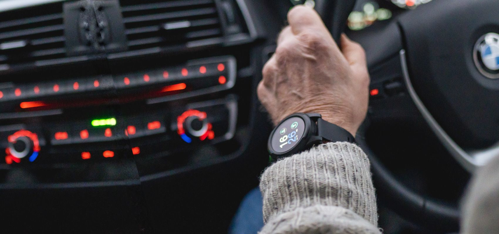 Close-up of an elderly person wearing a HelpAlert GPS smartwatch while driving