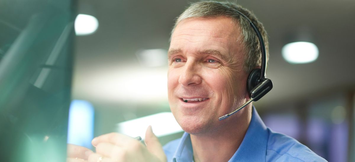 Man wearing a headset in an office setting